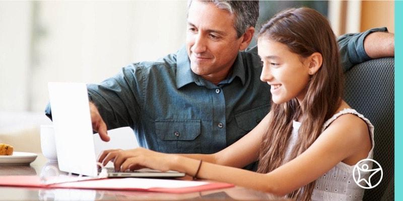 A learning coach helping his daughter create an online school schedule